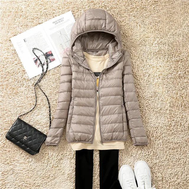 Insulated women's hooded jacket. A warm & lightweight puffer coat for outdoor style.