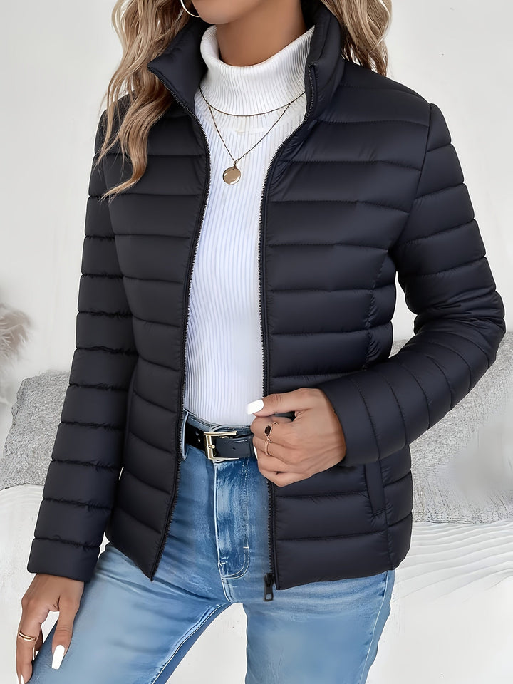 Cozy lightweight women's quilted jacket featuring a stylish stand collar. Great for fall & winter fashion.