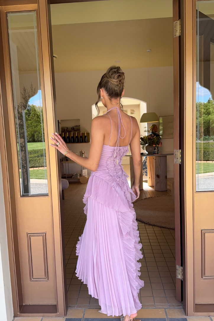 Close-up of lilac pleated ruffle halter midi dress. Features elegant pleated bodice & flowing ruffle skirt design.