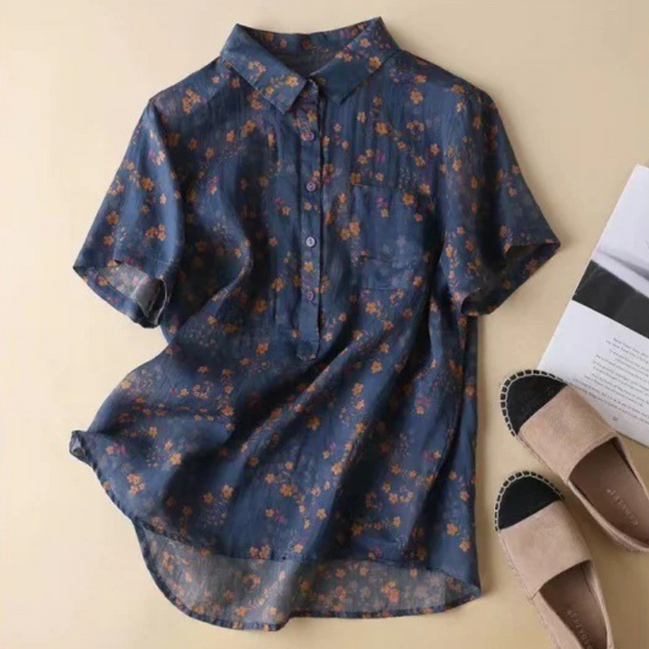 Versatile green floral half-placket blouse for women. Features button-up detail for casual or elegant spring wear.