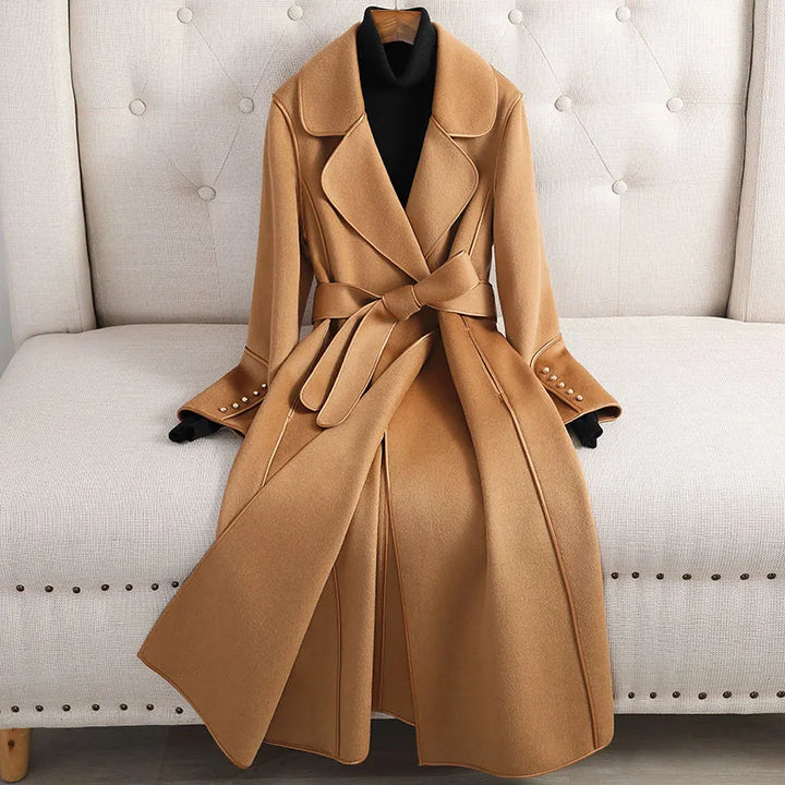 Women's long trenchcoat with belted waist, tailored fit. Classic outerwear for formal or casual fall fashion.