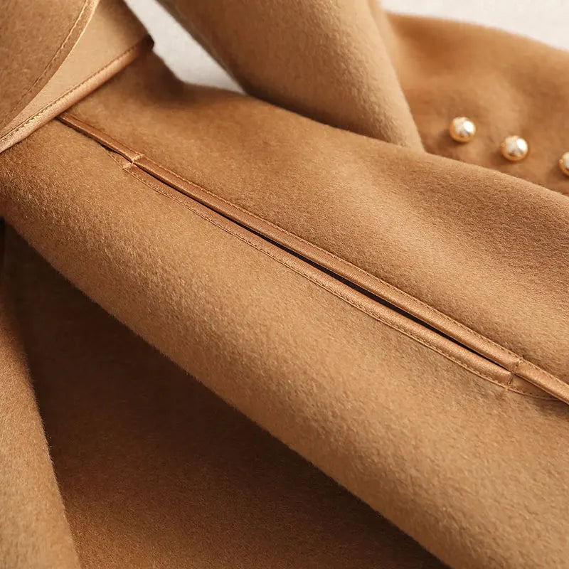 White women's long trenchcoat, belted waist & tailored fit. Chic outerwear for fall, winter, formal or casual.