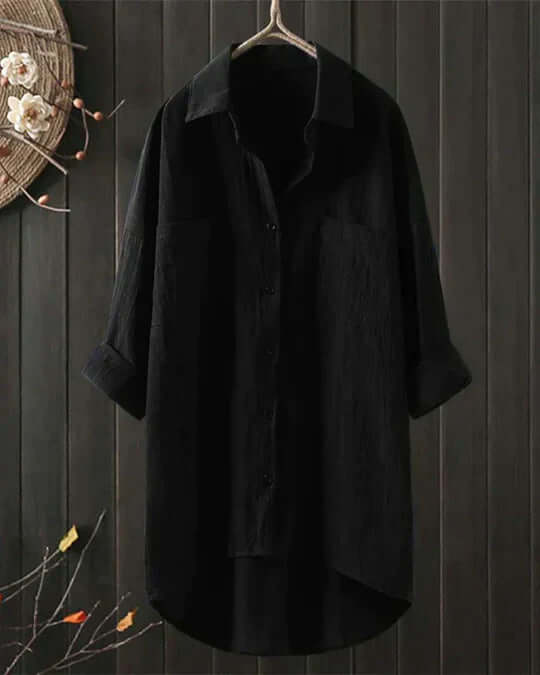 Relaxed fit women's collared blouse. Flowy button-up top with two pockets, ideal for comfortable casual style.
