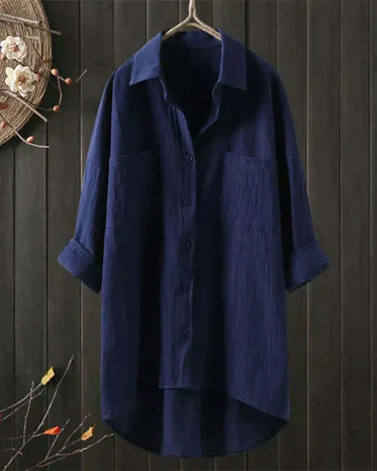 Everyday women's collared blouse with roll-tab sleeves, double pockets, and a longline fit. Casual summer top.