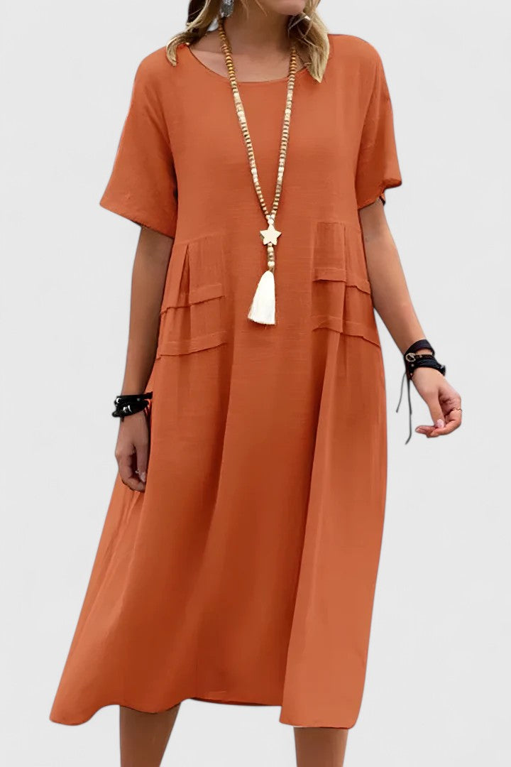 Women's loose fit midi dress with short sleeves & practical pockets, perfect for casual summer wear.