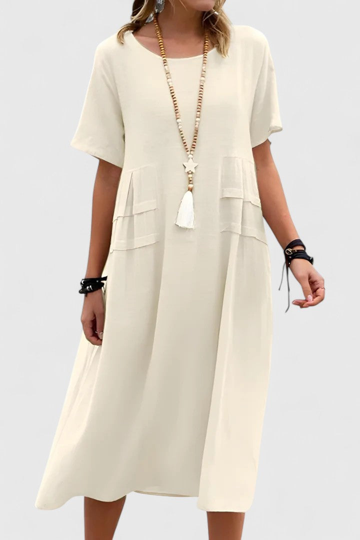 Comfortable women's midi dress with relaxed loose fit, short sleeves & pockets. Versatile for daily wear.