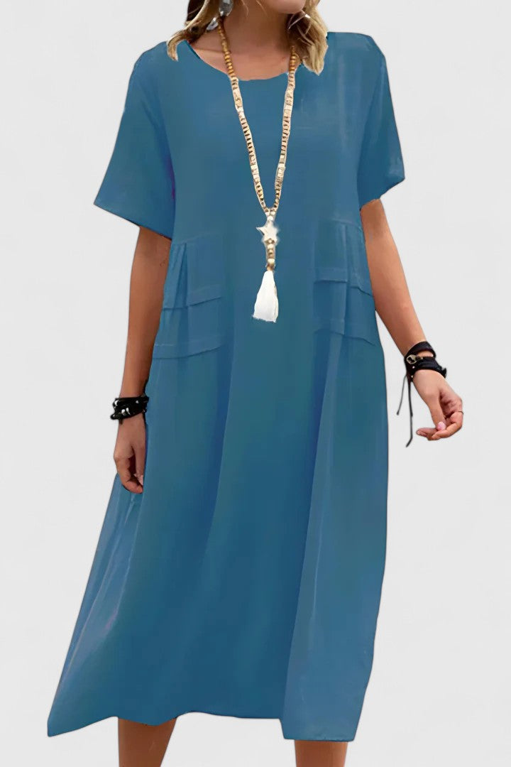 Casual women's short sleeve midi dress with pockets, ideal for comfortable summer days & holiday wear.