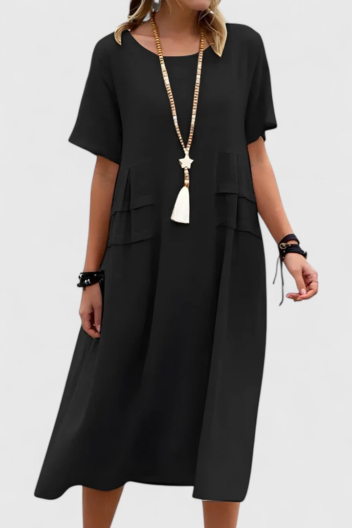 Versatile women's midi dress featuring a loose fit, short sleeves & handy pockets for ultimate comfort.