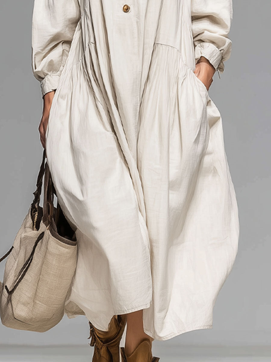 Stylish women's long-sleeve midi dress featuring a round neck, button-front, & practical double pockets. Casual everyday wear.