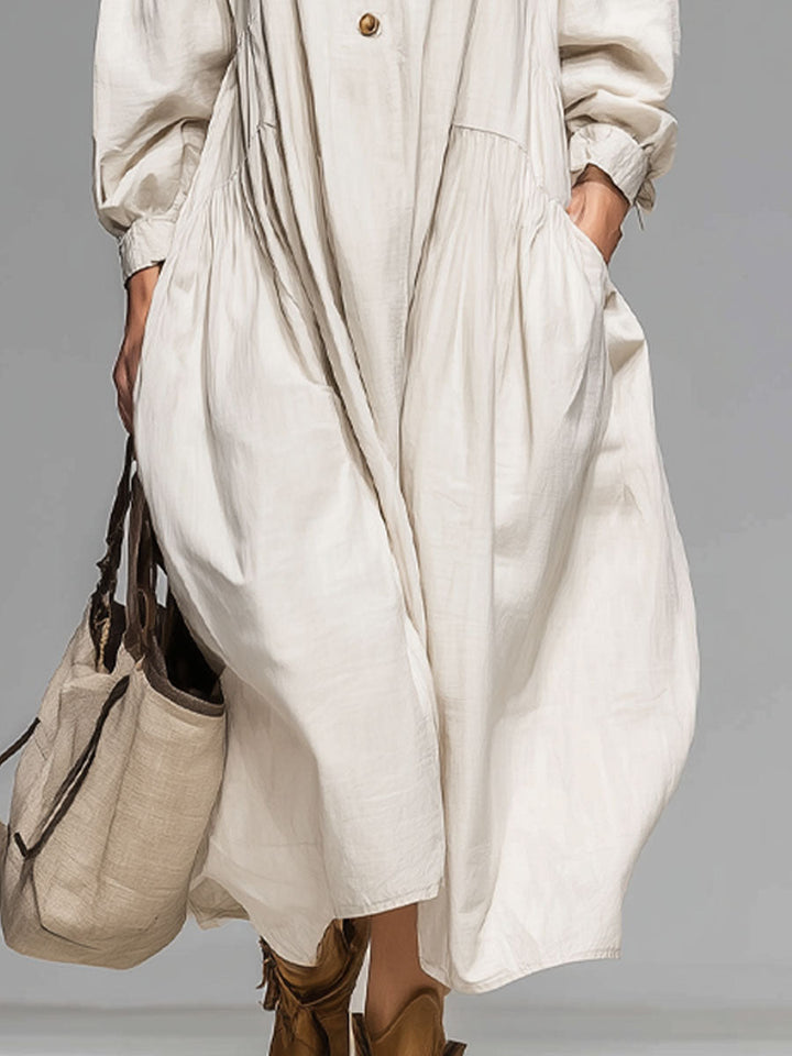 Stylish women's long-sleeve midi dress featuring a round neck, button-front, & practical double pockets. Casual everyday wear.