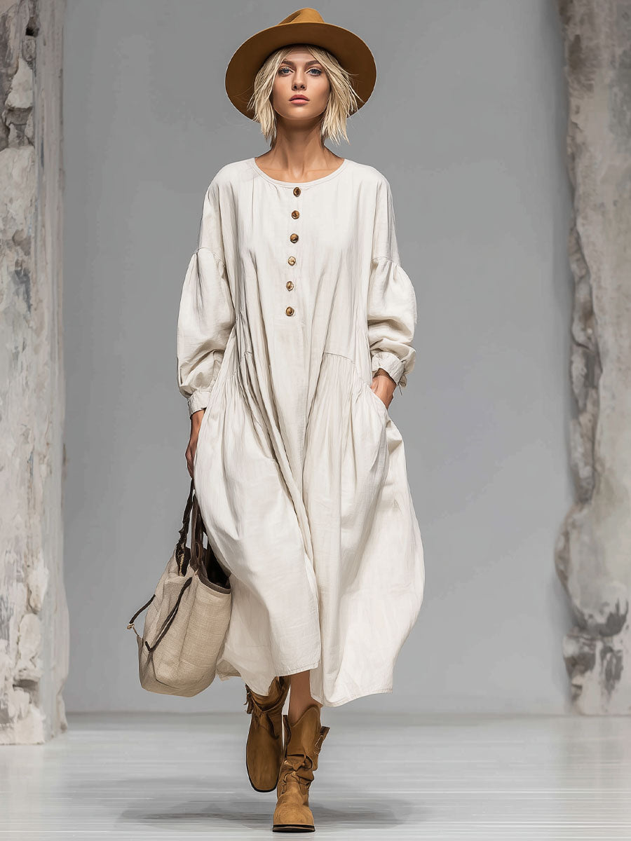 Relaxed women's midi dress with a loose fit, round neckline, full button front, & two convenient pockets. Ideal for fall.