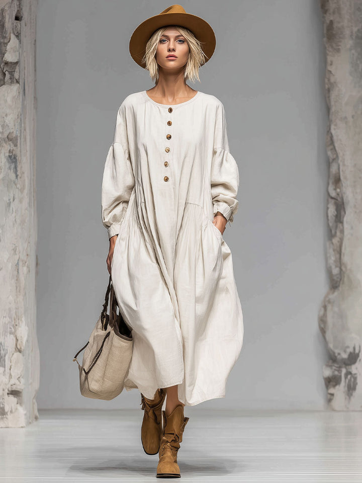 Relaxed women's midi dress with a loose fit, round neckline, full button front, & two convenient pockets. Ideal for fall.