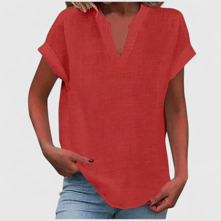 Women's comfortable loose fit blouse with V-neck, cap sleeves & a fashionable curved hem.