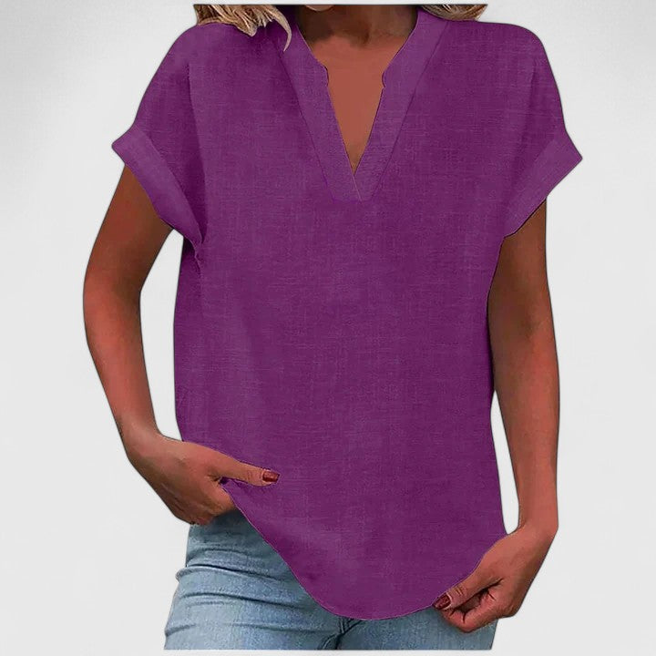 Stylish women's V-neck blouse, relaxed loose fit with comfortable cap sleeves & curved hem.