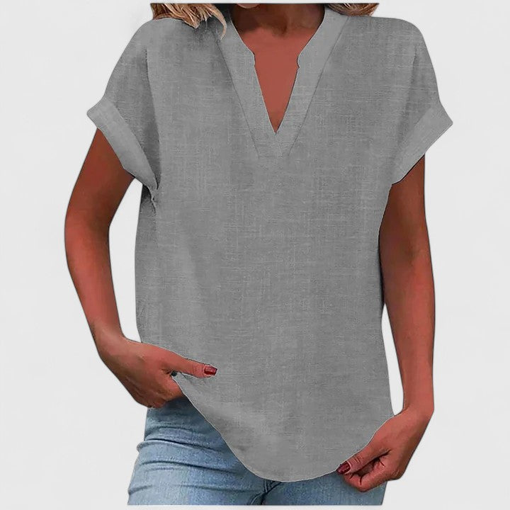 Everyday wear women's V-neck blouse, relaxed fit, cap sleeves, stylish curved hem.