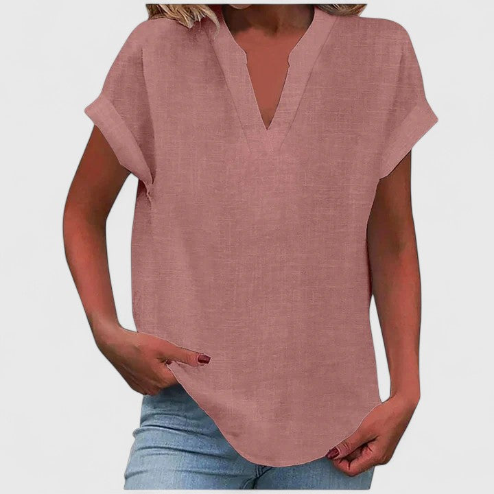 Relaxed fit V-neck women's blouse, comfortable & stylish, featuring cap sleeves & curved hem.