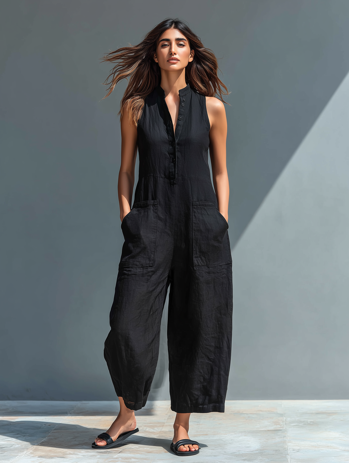Modern women's sleeveless jumpsuit. Features stand collar, button-up front, loose fit for casual comfort.