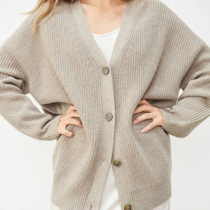 Draped women's oversized cardigan, elegant soft knitwear, perfect for luxurious and chic layering.