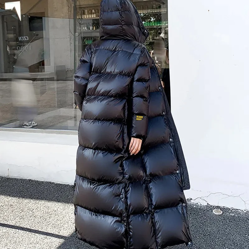 Elegant women's maxi hooded winter jacket, a long quilted coat for stylish warmth and protection.