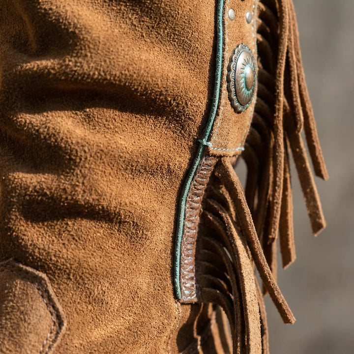 Women's slip-on mid-calf western boots. Stylish fringe detail, pointed toe, and sturdy block heel.