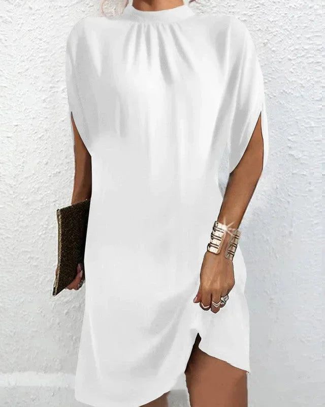 Stylish women's mock neck mini dress with dramatic cape sleeves, perfect for modern party fashion.