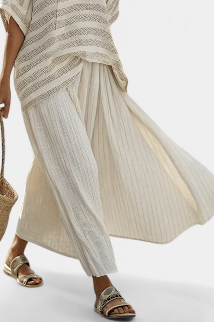Multi-colored striped batwing top & flowy maxi skirt set for women, a comfortable and stylish two-piece summer outfit.