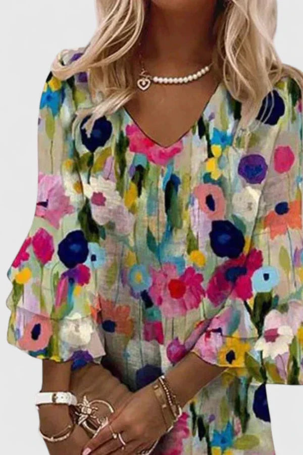 Vibrant floral print mini dress for women with V-neck and ruffled sleeves, ideal for beach days or casual outings.