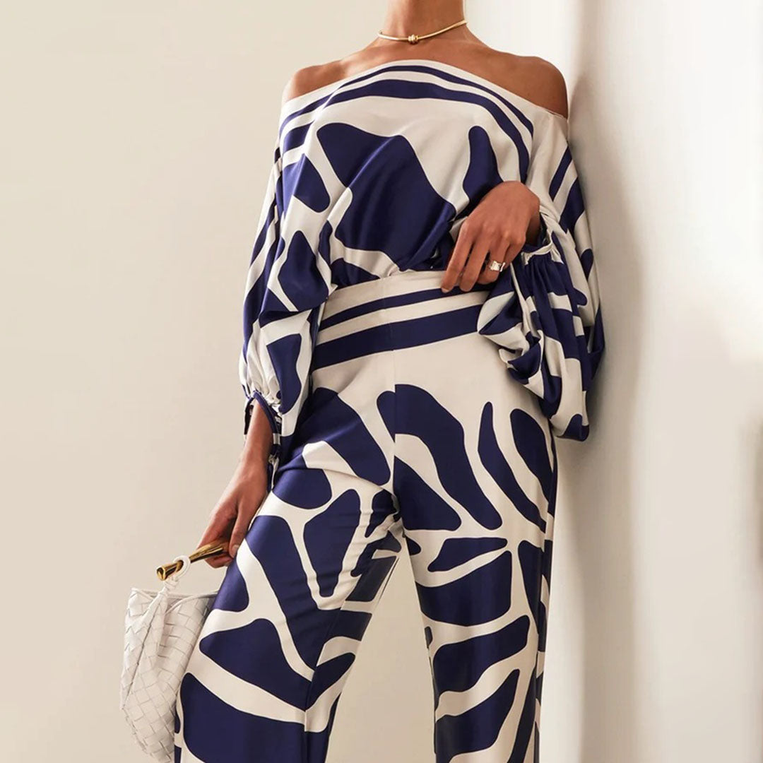 Vibrant women's off-shoulder printed summer two-piece outfit, a trendy choice for warm weather.