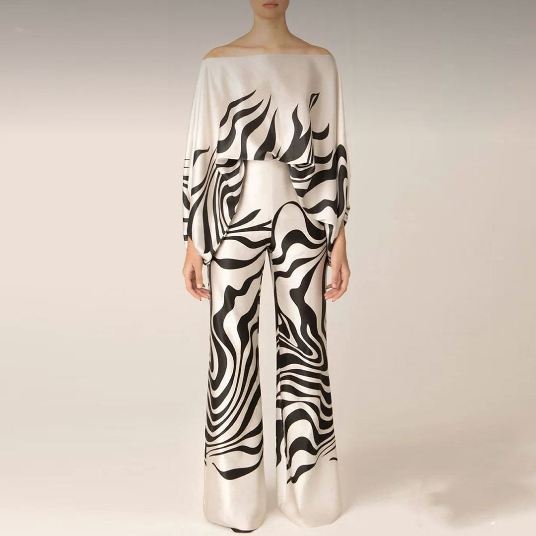 Stylish women's two-piece set featuring a vibrant printed one-shoulder top & comfortable wide-leg pants.