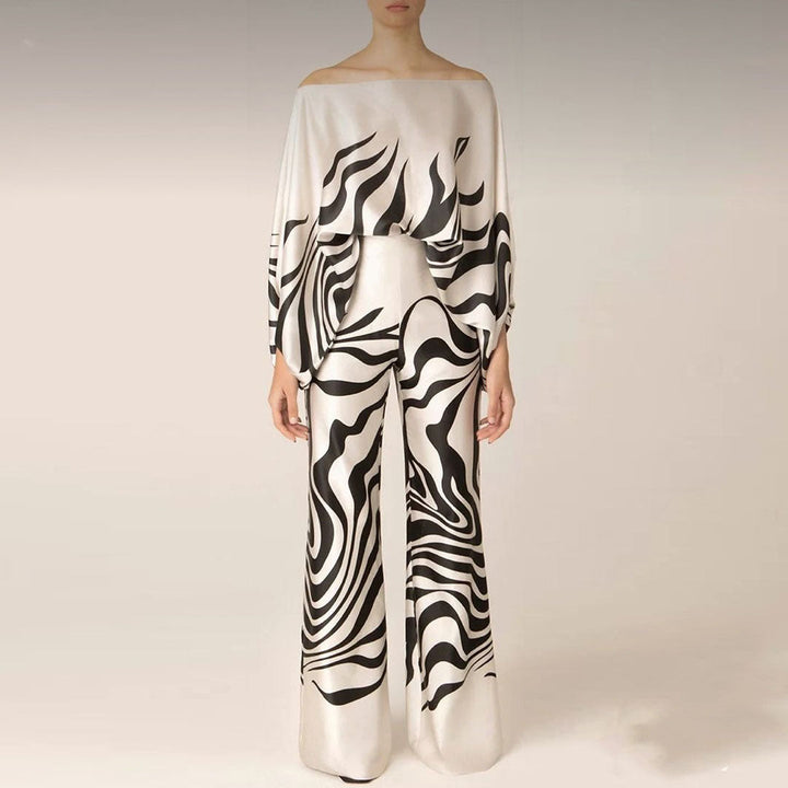 Stylish women's two-piece set featuring a vibrant printed one-shoulder top & comfortable wide-leg pants.