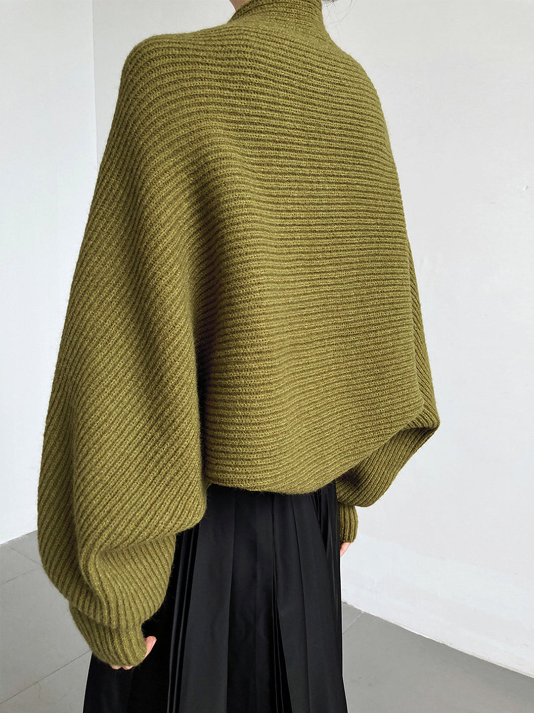 Woman wearing a comfortable open-front long sleeve shrug sweater. Regular fit, great for casual layering.