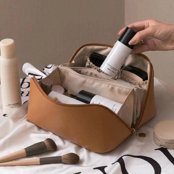 Open women's makeup organizer, showing spacious compartments for brushes, cosmetics & beauty essentials. Portable.