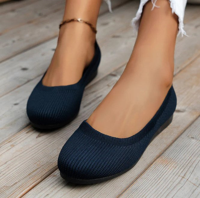 Woman wearing comfortable orthopedic ballet flats, ideal for walking & foot support.