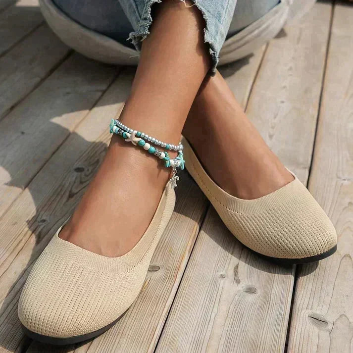 Close-up of comfortable women's orthopedic ballet flats, highlighting arch support detail.
