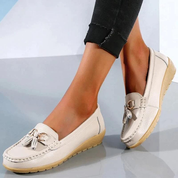 Woman walking in comfortable orthopedic slip-on loafers, ideal for daily commutes and lasting foot support.