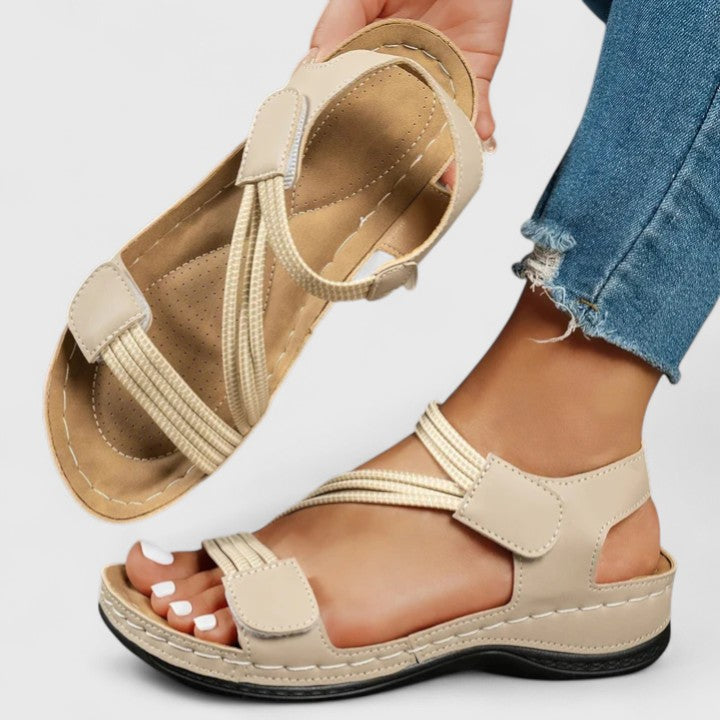 Underside of women's walking sandals, showing non-slip sole & three-arch support for stability.