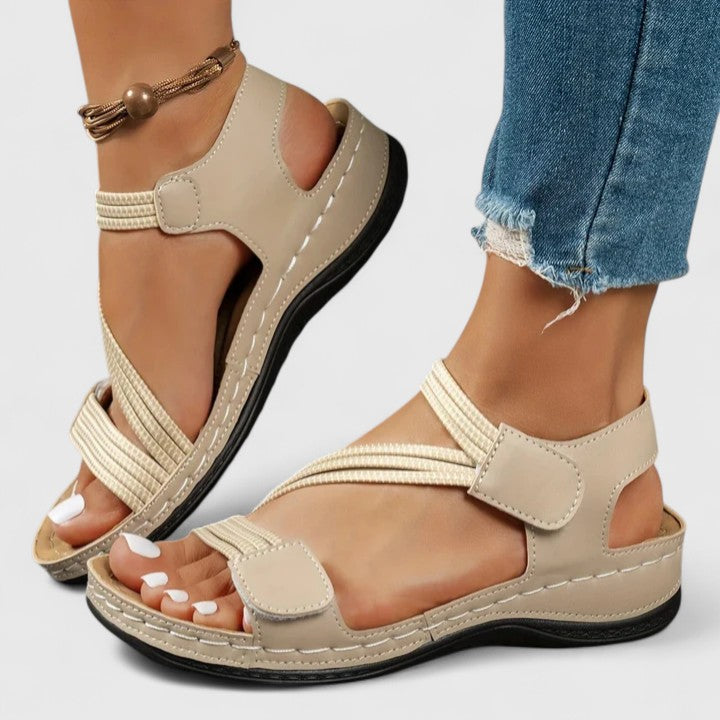 Side view of a women's orthopedic sandal, showcasing its ergonomic design for posture correction.