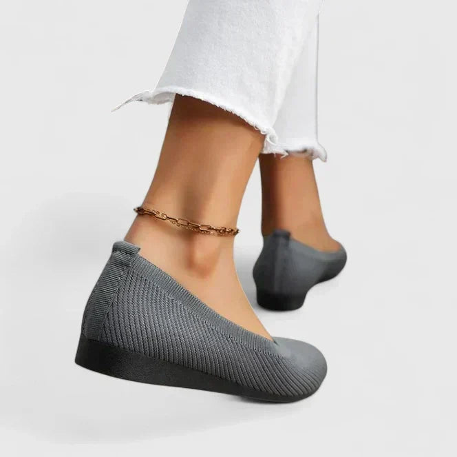 Pair of women's orthopedic slip-on walking shoes with arch support, featuring a non-slip design for relief.