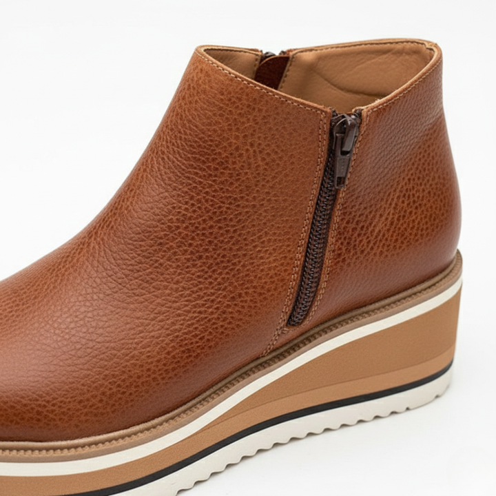 Stylish dark brown women's wedge heel ankle boots with a convenient side zipper, offering orthopedic comfort.