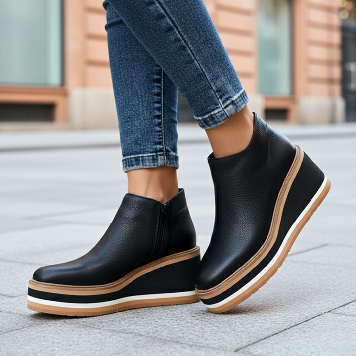 Light brown women's ankle boots featuring a supportive orthopedic wedge heel for all-day comfortable walking.