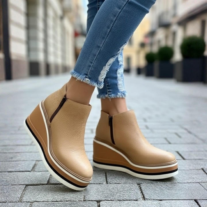 Women's comfortable wedge heel ankle boots, offering orthopedic support and versatile style for colder seasons.
