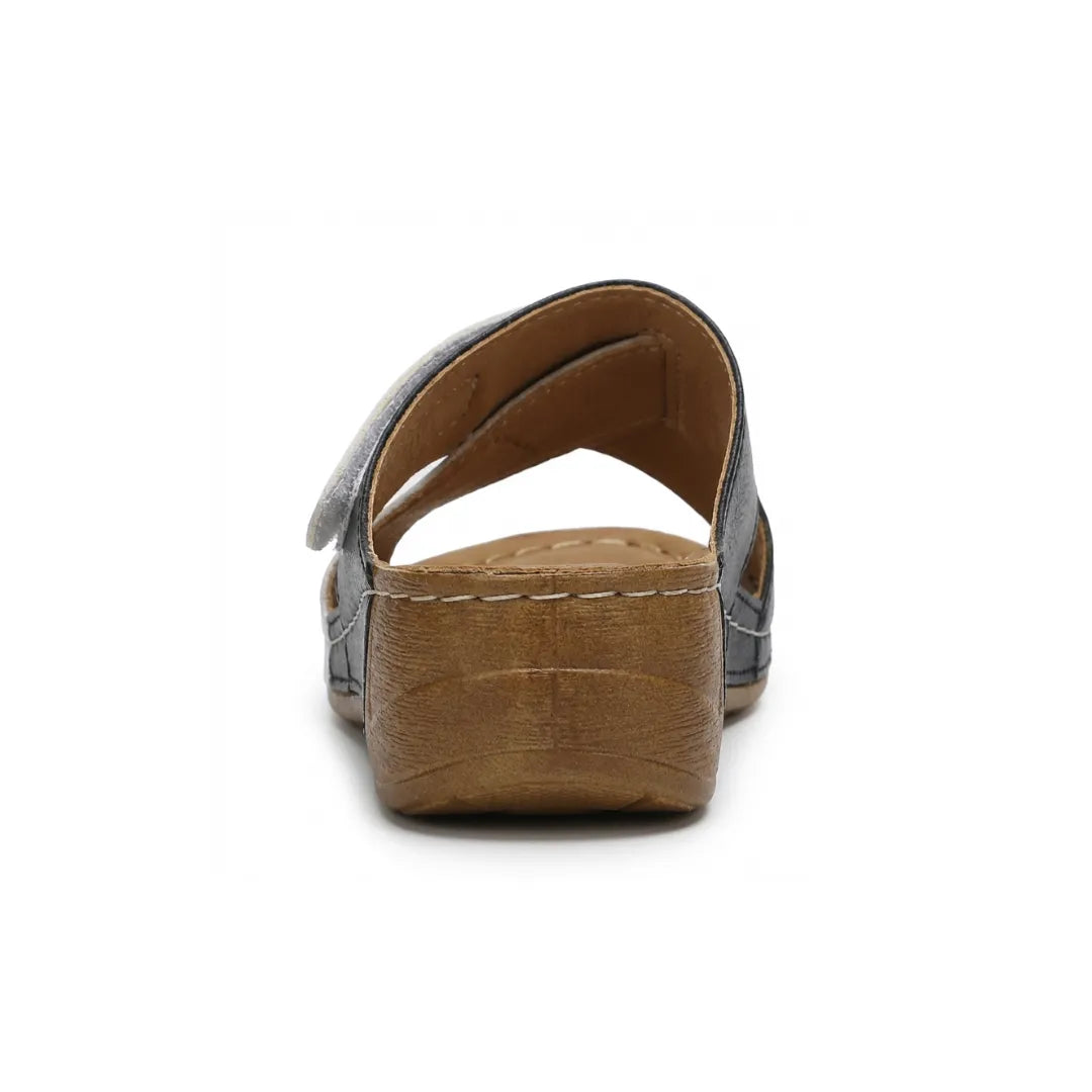Close-up of the cushioned footbed of women's orthopedic wedge sandals in tan.