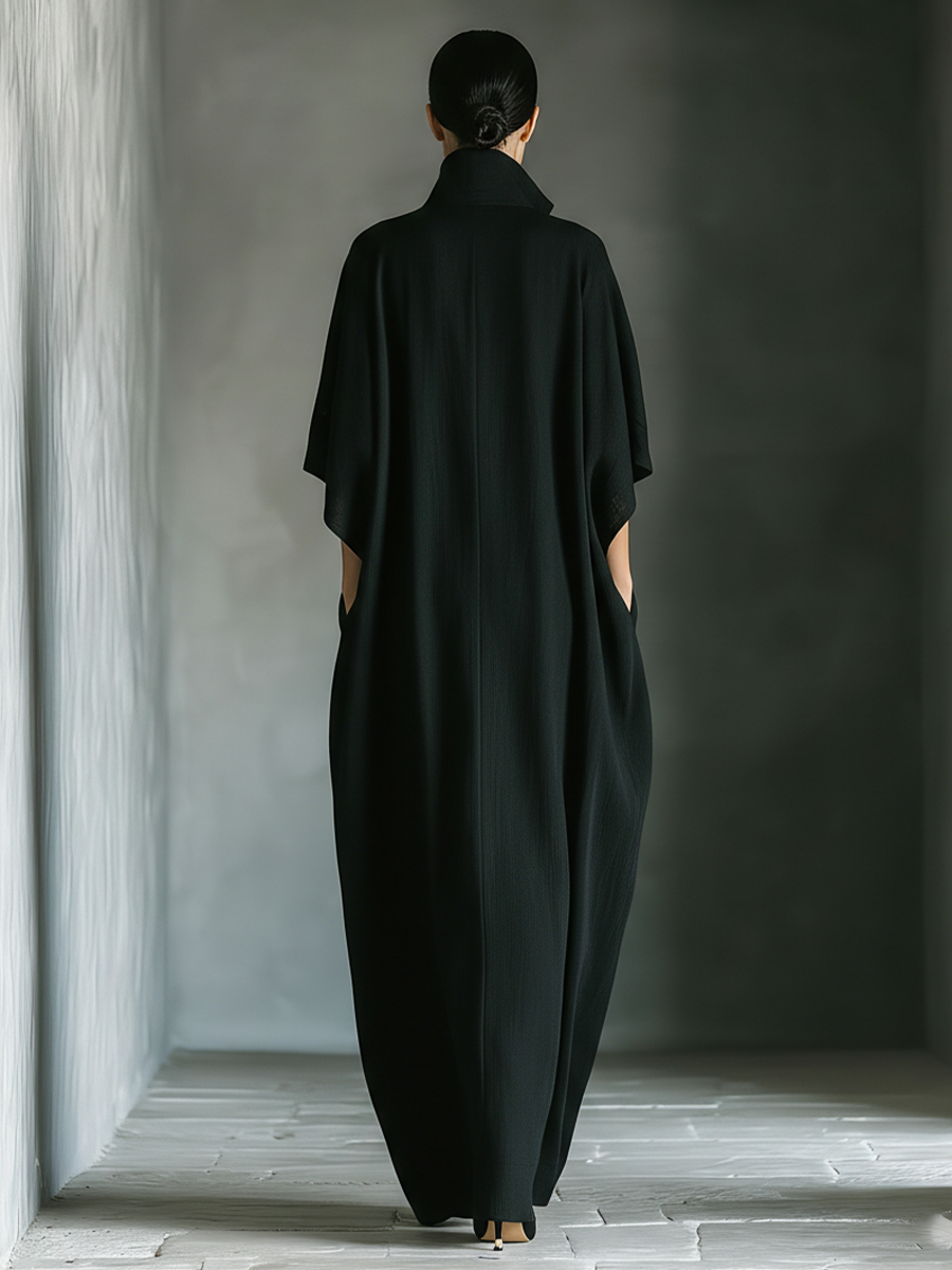 Elegant women's oversized V-neck maxi dress with kimono sleeves, pockets; a versatile travel outfit.
