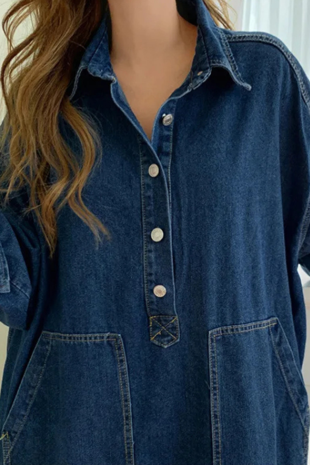 Relaxed fit women's oversized maxi shirt dress in blue. Features button front, long sleeves, and practical pockets.