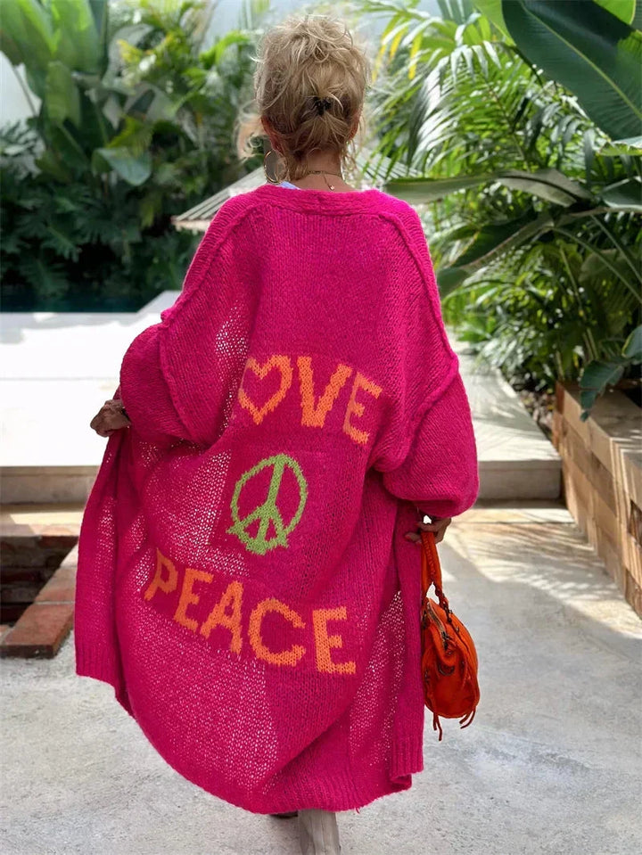 Women's oversized bohemian knit cardigan with 'Love Peace' slogan & colorful design.