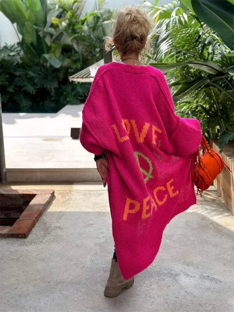 Relaxed fit women's long oversized bohemian knit cardigan, with colorful 'Love Peace' design.