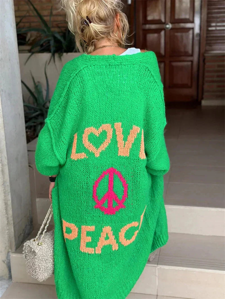 Statement outerwear: women's oversized bohemian knit cardigan with 'Love Peace' symbol & longline style.