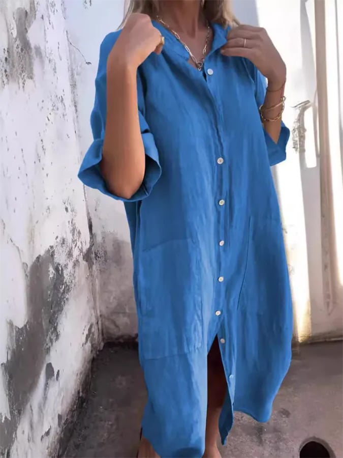Chic women's midi length oversized shirt dress featuring a button-down design and practical pockets. Summer wear.
