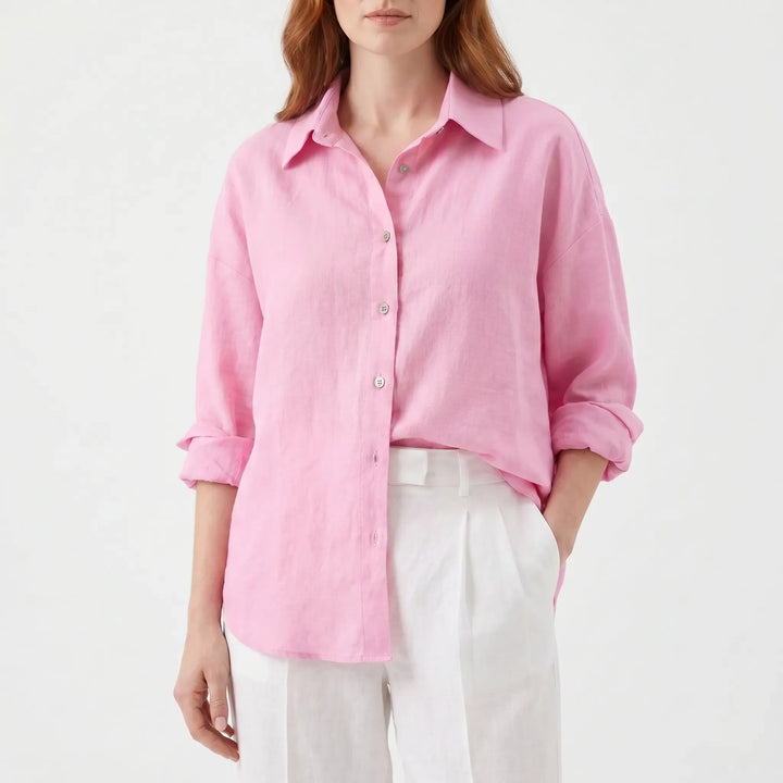 Detail of a women's oversized button-down shirt, showcasing the turn-down collar and front button placket.