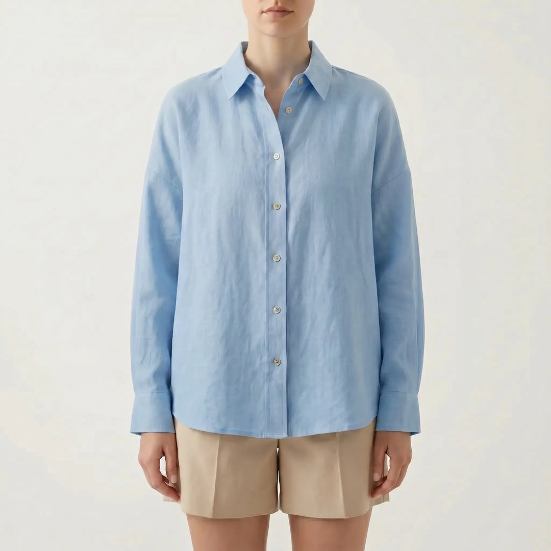 Rear view of a versatile women's oversized button-down shirt, highlighting its relaxed fit and long sleeve design.